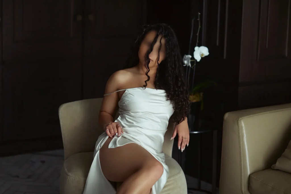 ari abella posing in white dress